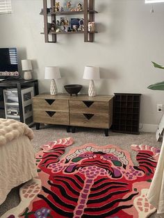 a bed room with a neatly made bed and dressers