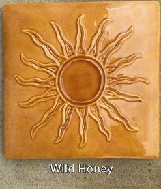 a ceramic tile with the sun on it