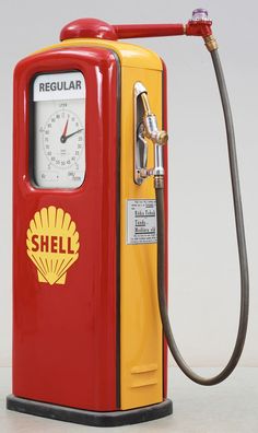 a red and yellow shell gas pump sitting on top of a table