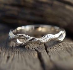 a silver ring sitting on top of a wooden table