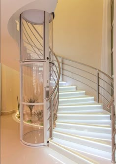 a spiral stair case in the middle of a room with white walls and flooring