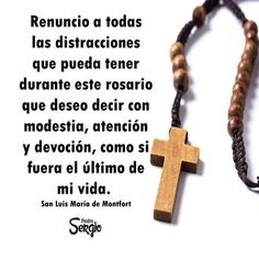 a wooden cross on a black cord with spanish words in the middle and an image of jesus