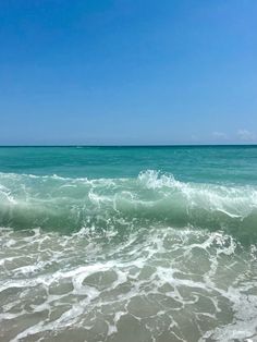 the ocean is blue and green with white waves