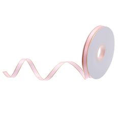 a roll of pink satin ribbon on a white background