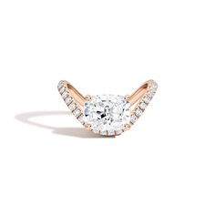 an oval shaped diamond ring set in 18k rose gold