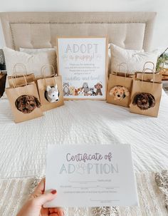 a person holding up a paper sign in front of a bed with bags on it