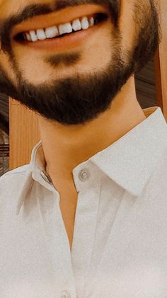 a close up of a person wearing a white shirt