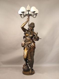 a bronze statue with two lights on top of it