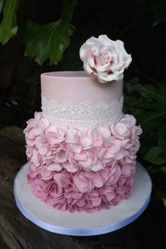 a pink and white wedding cake with flowers on the top is featured in an instagram post