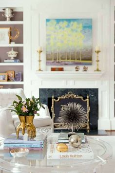 a living room filled with furniture and a fire place in the middle of a room