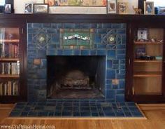 a living room with a fire place and bookshelves on the wall above it