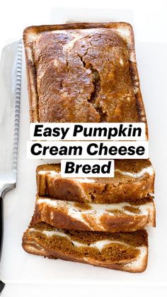 two pieces of bread sitting on top of a cutting board with a knife next to it