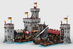 a lego castle with two towers and flags on it's roof, sitting in front of a white background