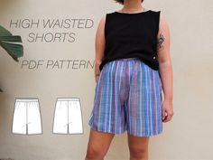 a woman standing in front of a wall with her hands on her hips wearing shorts