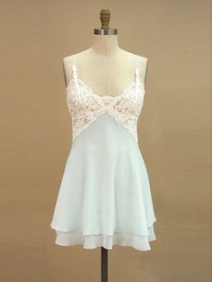 a dress on a mannequin with a white top and lace overlays