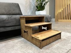 a dog house made out of plywood with a white bone in the bottom drawer