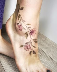 a close up of a person's foot with flowers on the bottom and side