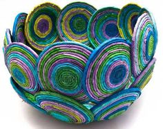 a bowl made out of paper with colorful circles on it's sides and bottom