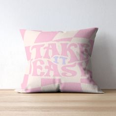 a pink pillow sitting on top of a wooden table