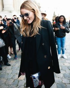 a woman wearing sunglasses and a black coat