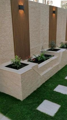 a row of planters sitting next to each other on top of grass