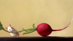 a painting of a mouse and a radish on top of a wooden table