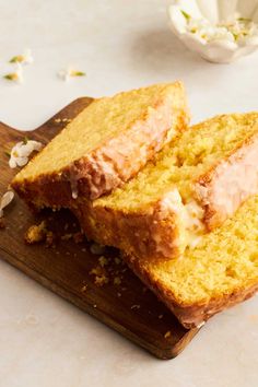 two slices of cake sitting on top of a wooden cutting board