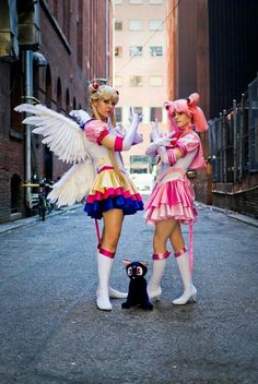 two women dressed in costumes standing next to each other