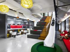 the interior of an office with modern furniture and lighting in white, green, yellow and red colors