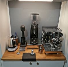 there is a coffee maker and other items on the counter in this small kitchen area