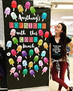 a woman standing next to a sign with ice cream on it