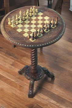 a wooden table with chess pieces on it