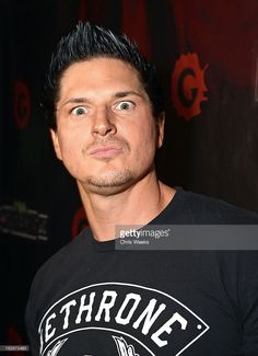 a man with black hair wearing a black shirt