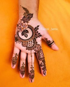 a hand with henna tattoos on it