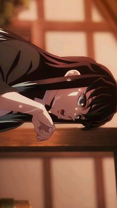 an anime character laying down on a table with her head resting on the back of another person's shoulder