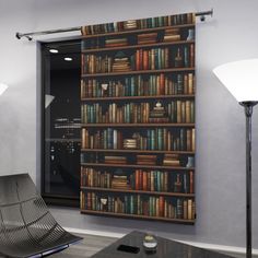 a living room filled with furniture and a book shelf next to a window covered in books