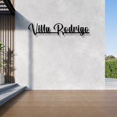 a white wall with the word villa redring on it and a plant next to it