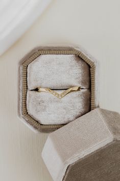 an engagement ring in a box on top of a table