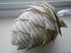 an origami pine cone sitting on top of a window sill