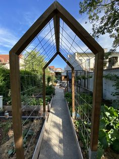 a wooden walkway leads to an outdoor garden