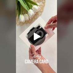 someone holding up a camera card with flowers in front of it and the text diy camera card