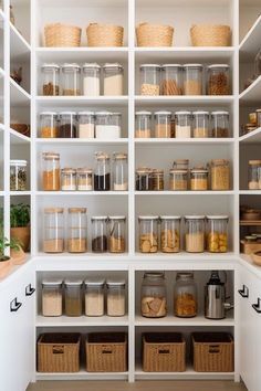 an organized pantry with lots of containers and baskets on the shelves in front of them