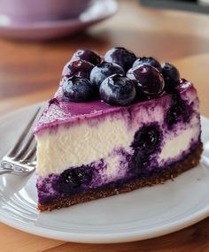 a slice of cheesecake with blueberries on top