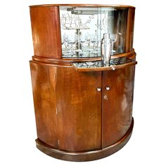 an old fashioned wooden cabinet with glassware in it