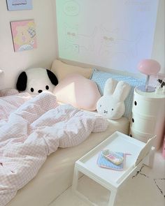 a child's bedroom with stuffed animals on the bed