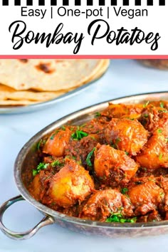 an easy one - pot vegan bombay potatoes recipe in a silver pan with tortillas on the side