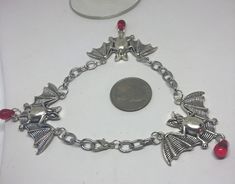 Large silver bat bracelet. Bats are lead and nickel free as well as the chains. Bats encircle your wrists with a small red teardrop glass  bead dangling below. Great for halloween or anytime youre feeling batty ! Bat Bracelet, Flying Bat, Blossom Bracelet, Halloween Bracelet, Steampunk Gears, Silver Heart Earrings, Beaded Dangles, Bracelet Stack, Charm Bracelets