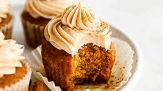 cupcakes with frosting and nuts on a plate