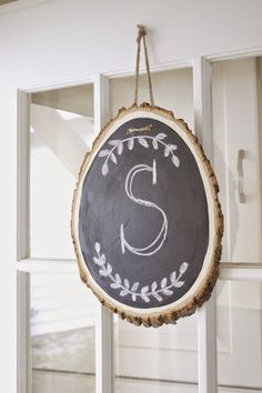 a chalkboard sign hanging from the side of a door