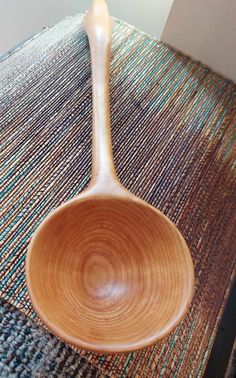 a wooden spoon sitting on top of a rug